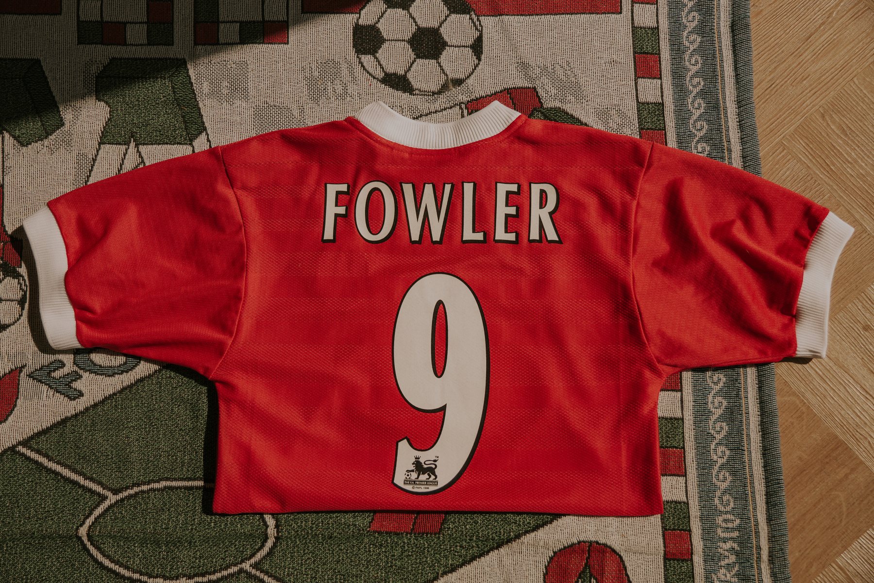 Vintage red shirt with a number 9 on the back, on a football rug