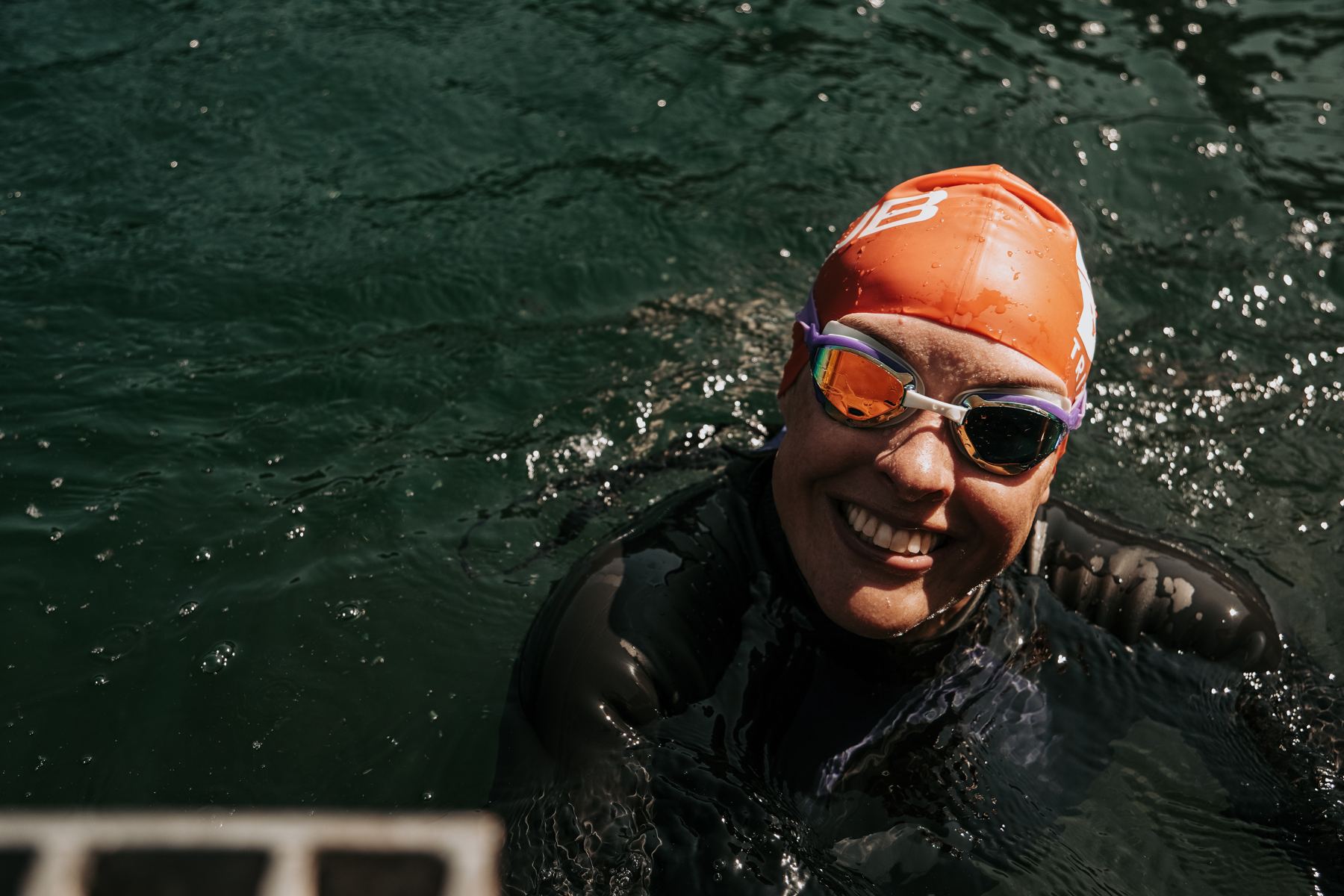 Dee Allen smiling mid-swim