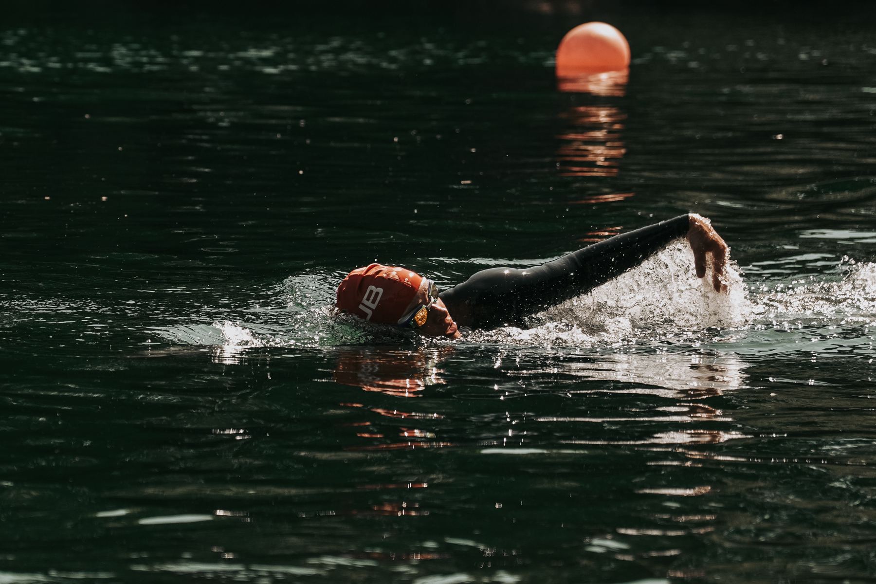 Dee Allen swimming past a buoy