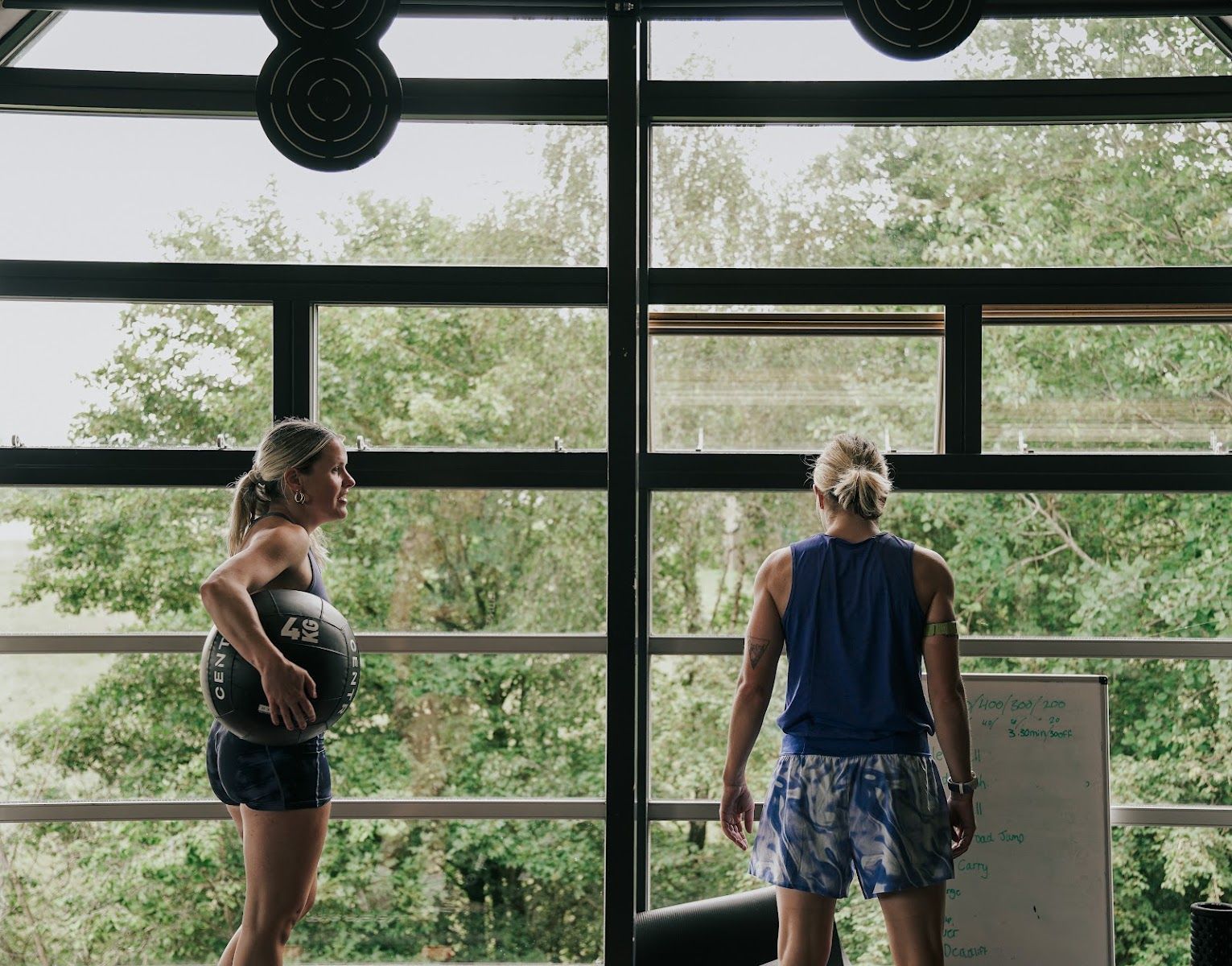 Dee and her sister by the gym windows
