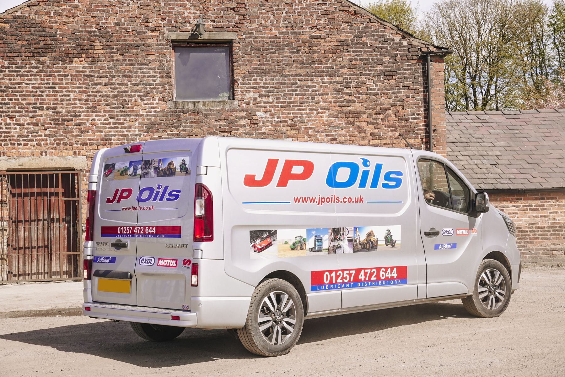 JP Oils van outside a brick barn