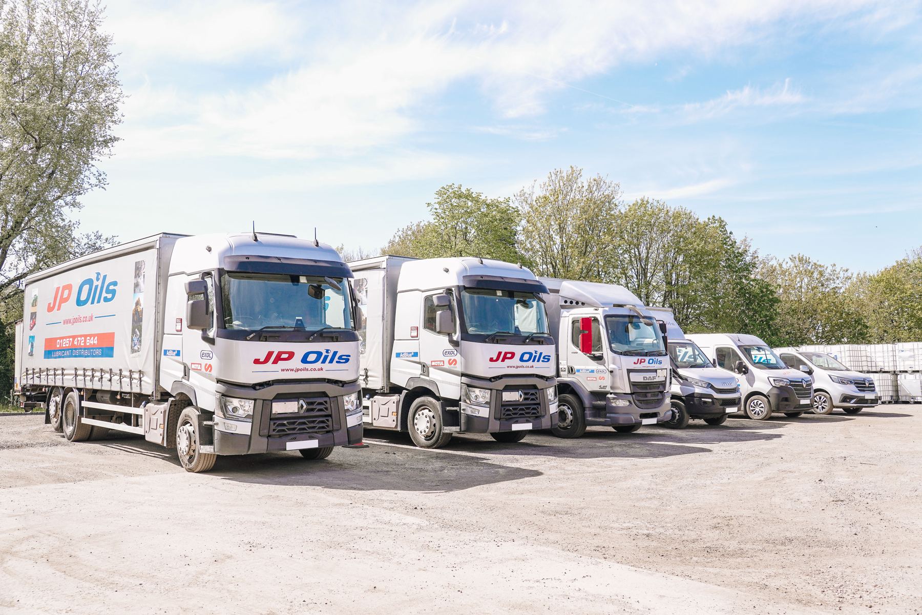 JP Oils vans and lorry in the yard